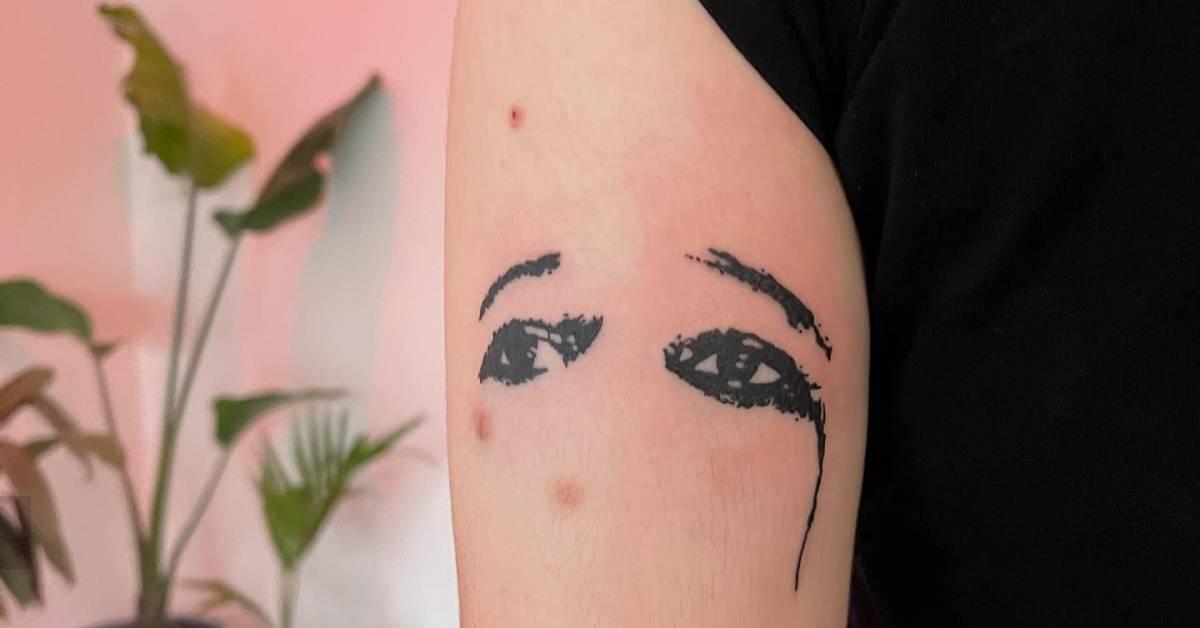 Crying eyes tattoo placed on the upper arm,