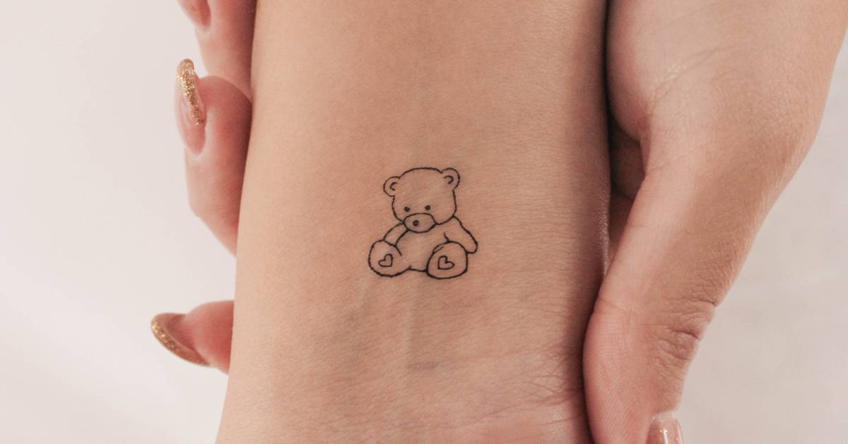 Fine line style teddy bear temporary tattoo located on