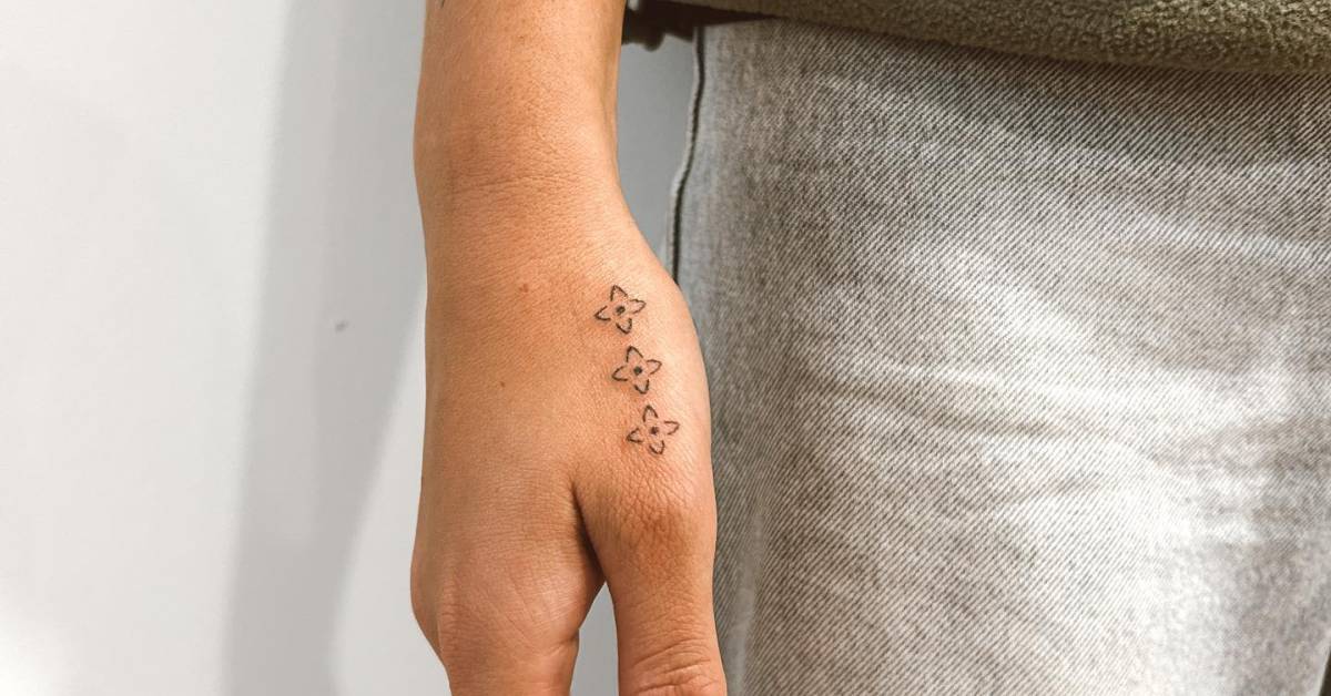 Hand poked ornaments tattooed on the hand.