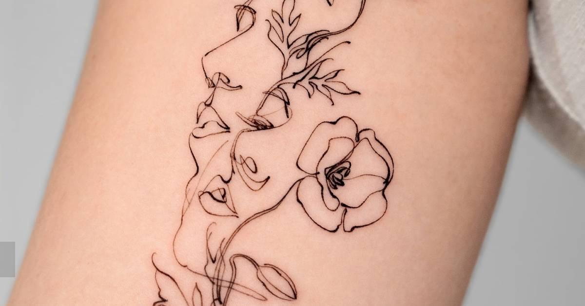 Flower head women tattoo located on the inner arm.