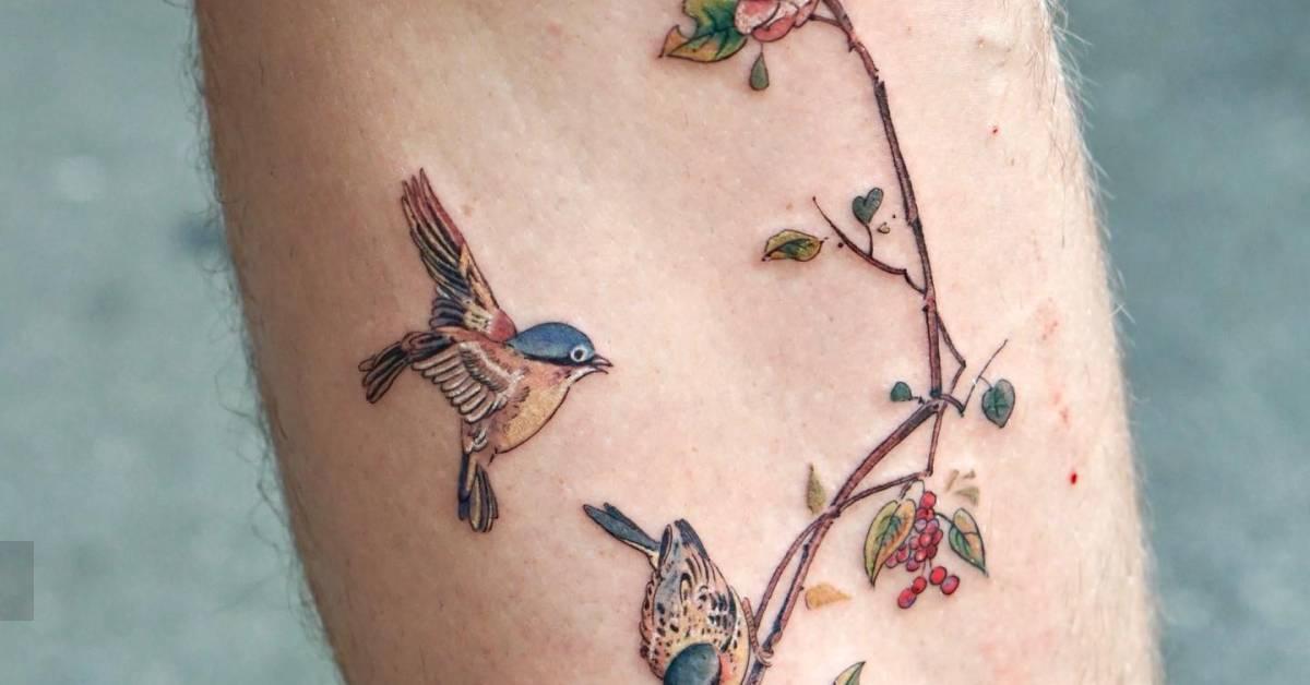 Birds on a branch tattoo located on the calf,