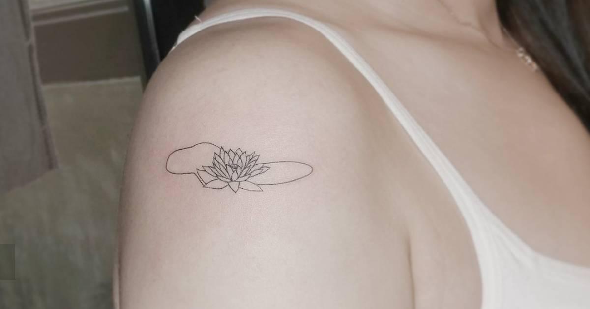 Fine line style lotus flower tattoo done on the
