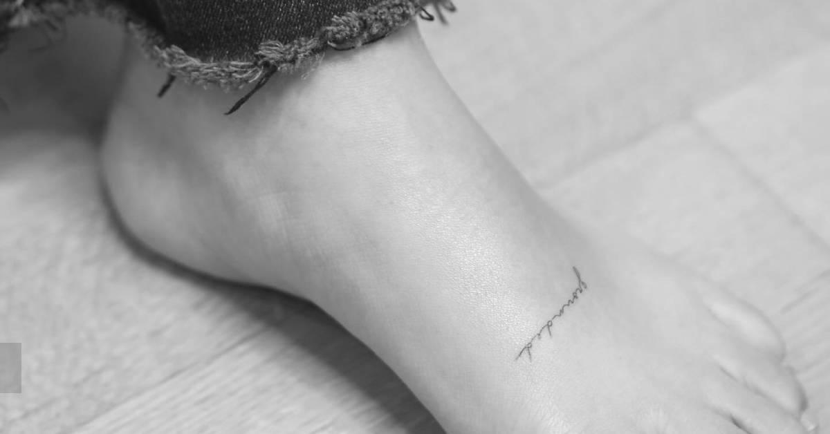 Handwritten style lettering tattoo placed on the foot.