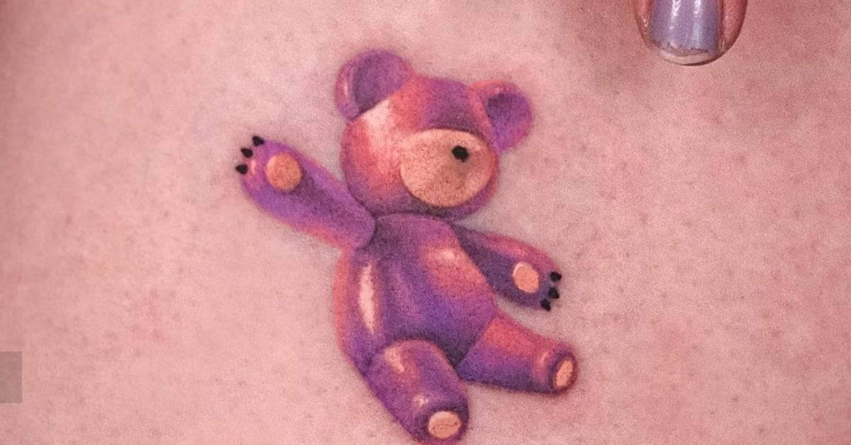 Watercolor style teddy bear tattoo located on the