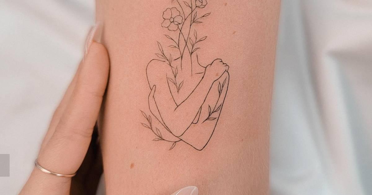 Flower head woman tattoo in fine line style located on