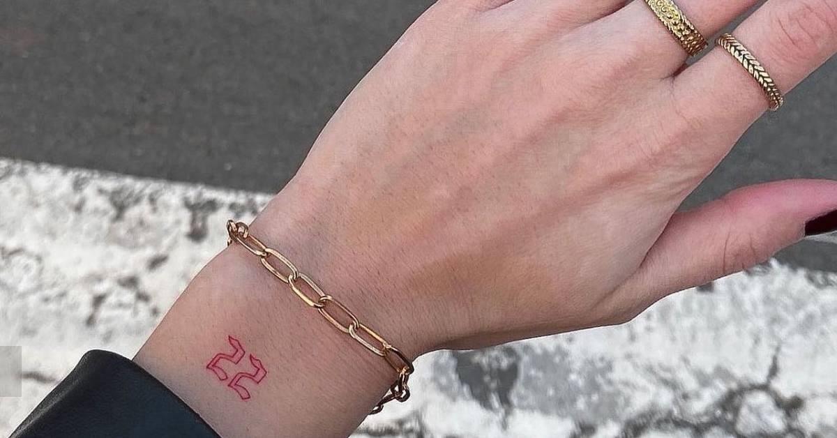 Tattoo of the number "22" in red ink located on the