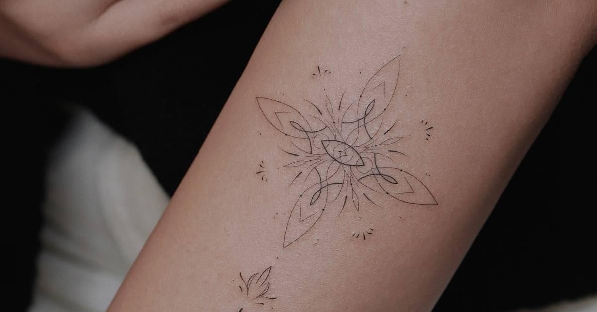 Fine line style ornamental tattoo located on the