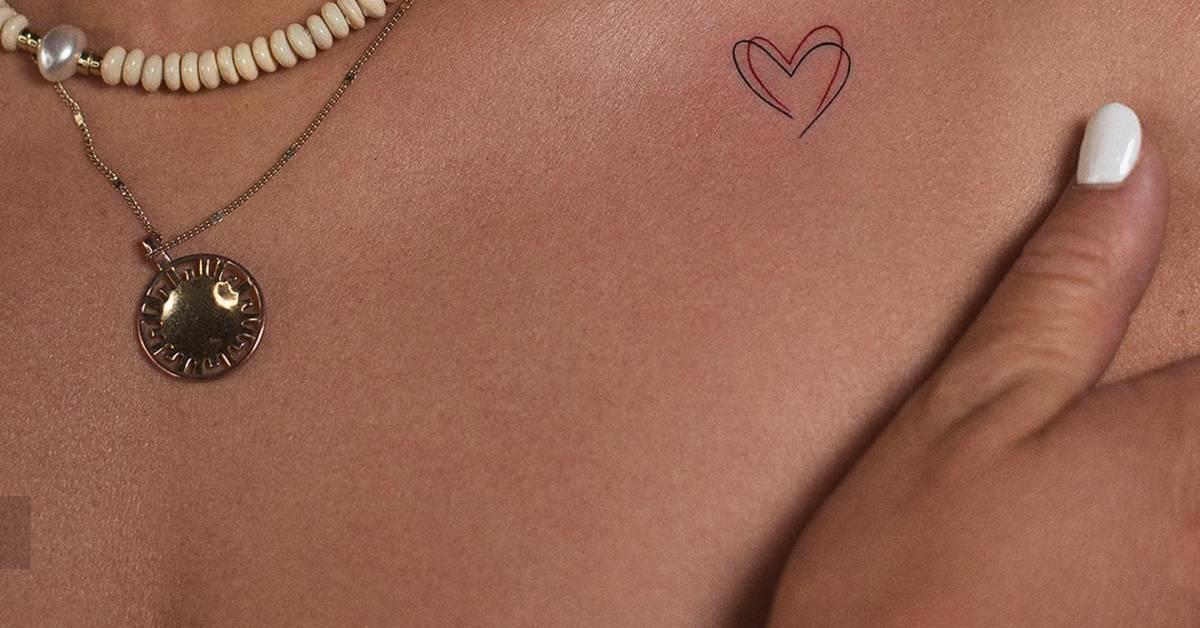 Minimalistic style heart tattoo located on the