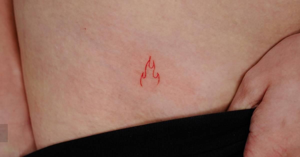 Minimalistic style red fire tattoo located on the