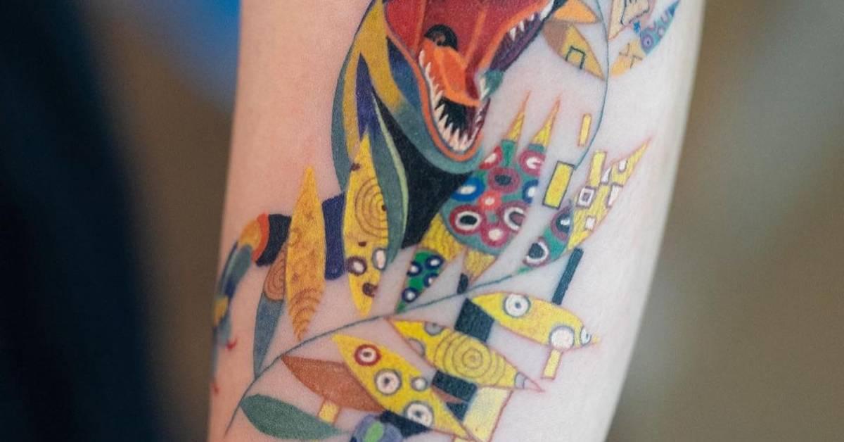 Velociraptor And Palm Leaves Tattoo Located On The velociraptor-and-palm-leaves-tattoo-located-on-the