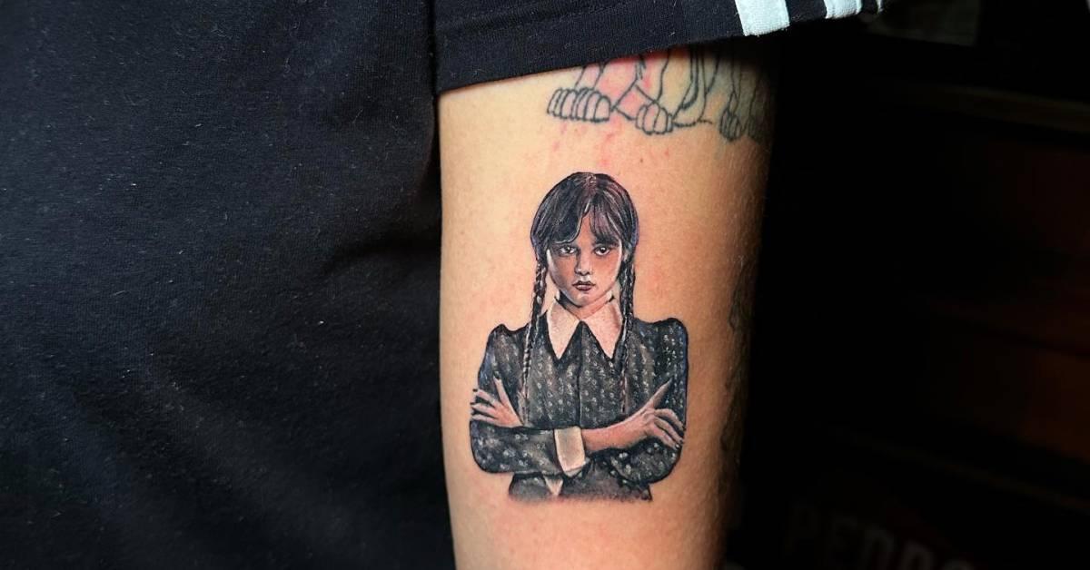 Wednesday Addams tattoo located on the upper arm,