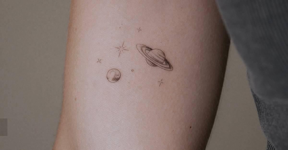 Tiny galaxy tattoo located on the inner arm.