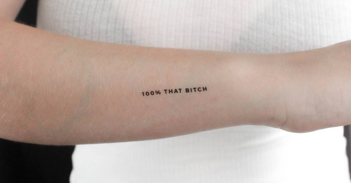 "100 THAT BITCH" temporary lettering tattoo located on