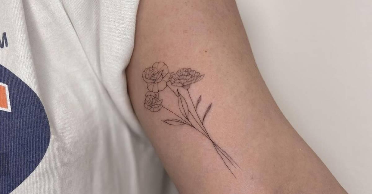 Fine line flower bouquet tattoo located on the inner