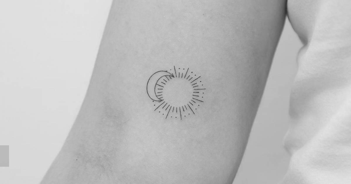 Fine line style sun and moon tattoo done on the inner
