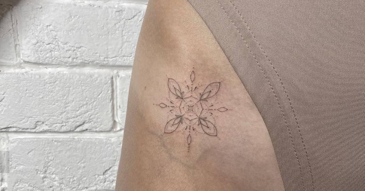 Fine line style ornament tattoo hand poked on the