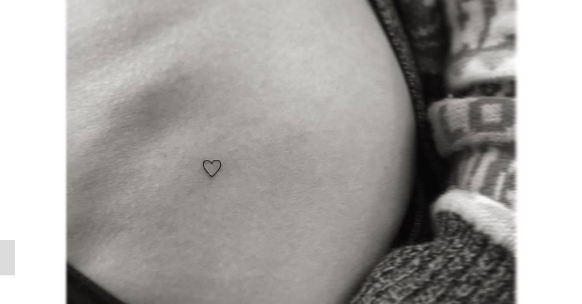 Tiny minimalistic heart tattoo located on the pelvis.