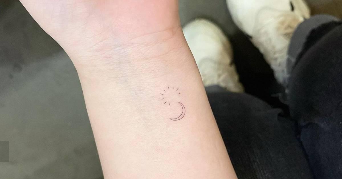 Minimalistic style sun and moon tattoo located on the