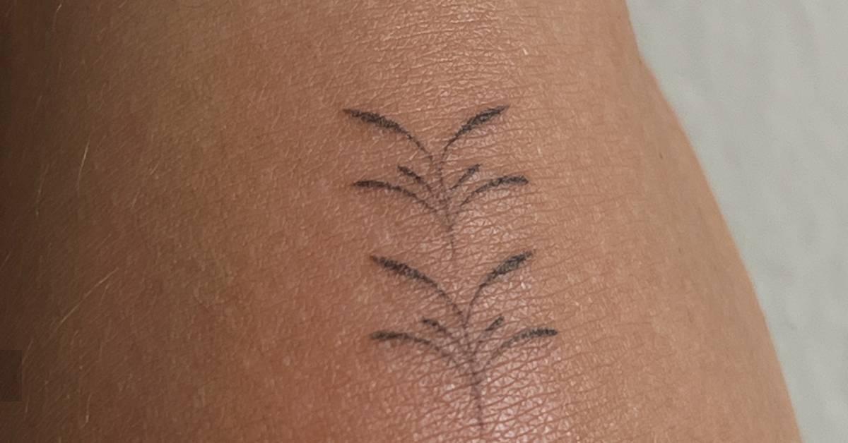 Little leaves ornament tattoo hand poked on the