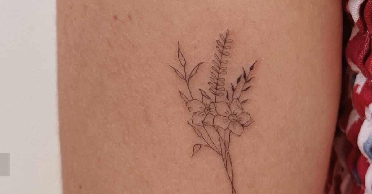 Flower bouquet tattoo in fine line style located on the