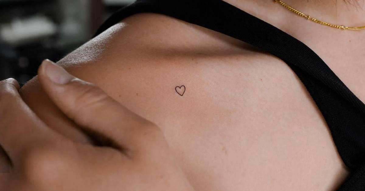 Tiny heart tattoo in minimalistic style located on the