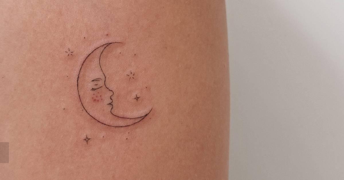 Moon face tattoo in fine line style located on the