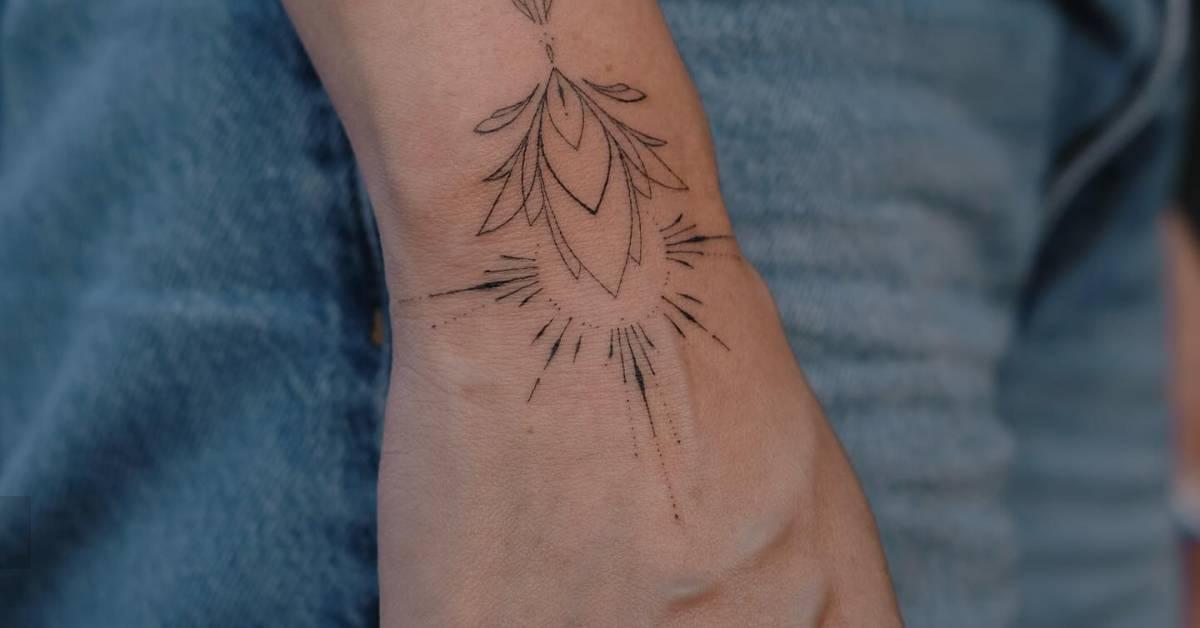Hand poked ornamental lotus flower tattoo placed on the
