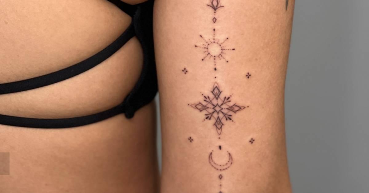 Fine line style ornamental sun and moon tattoo located