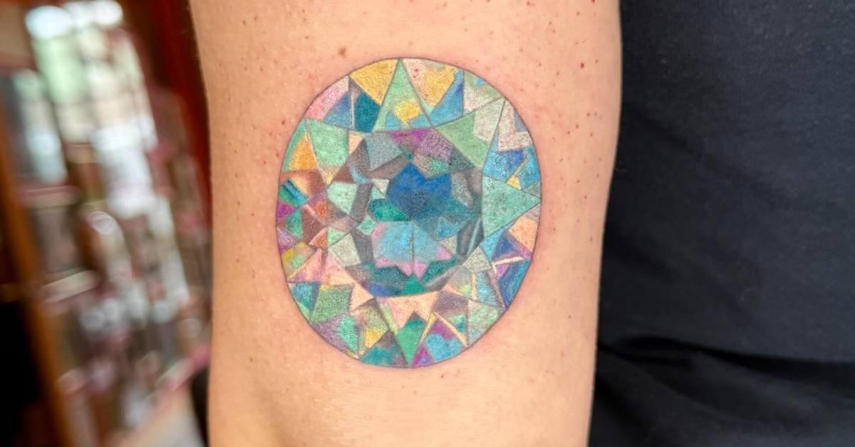 Gemstone tattoo located on the tricep, illustrative