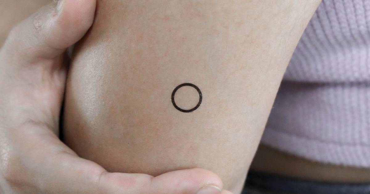 Little circle temporary tattoo in minimalistic style