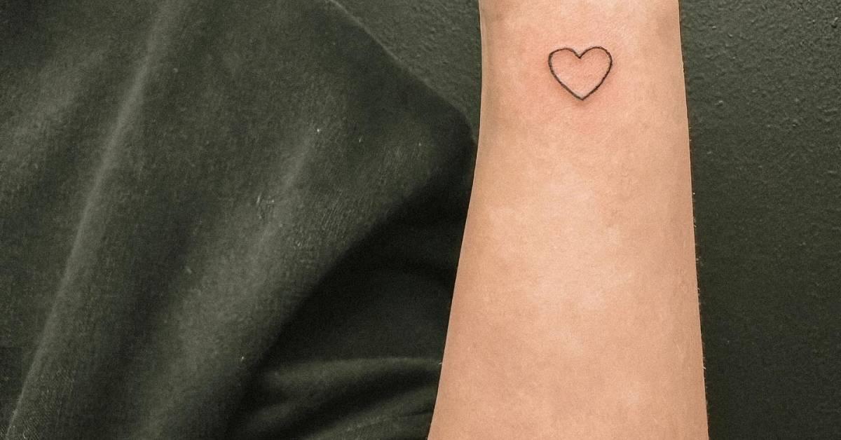 Minimalistic heart tattoo placed on the wrist.