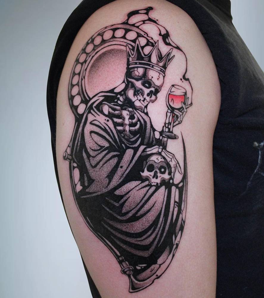 King skeleton tattoo located on the upper arm, comic style.
