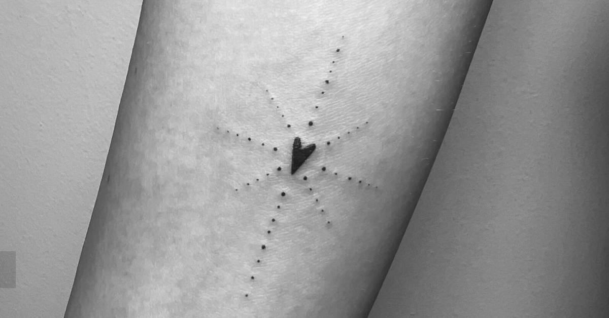 Ornamental heart tattoo located on the inner forearm.