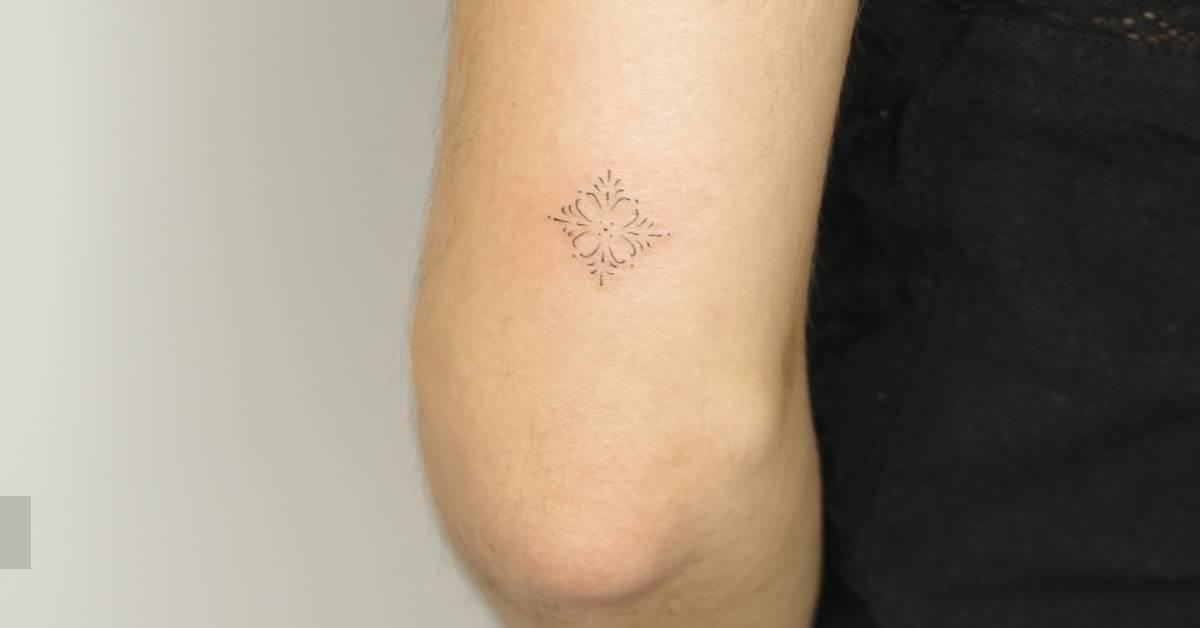 Fine line style ornamental tattoo located on the