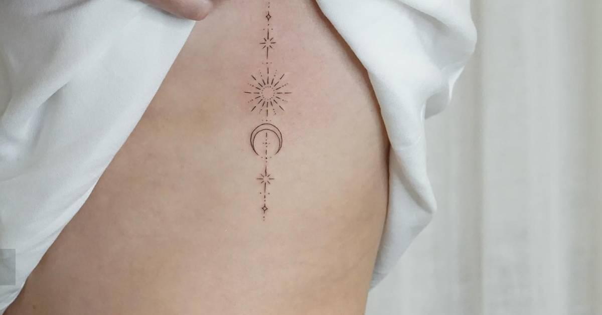 Fine line style ornamental sun and moon tattoo placed