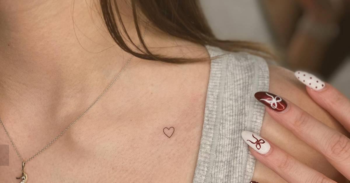 Tiny minimalistic heart tattoo placed on the