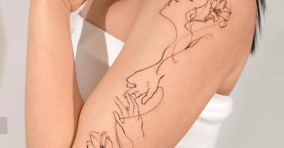Flower head woman tattoo placed on the upper arm,