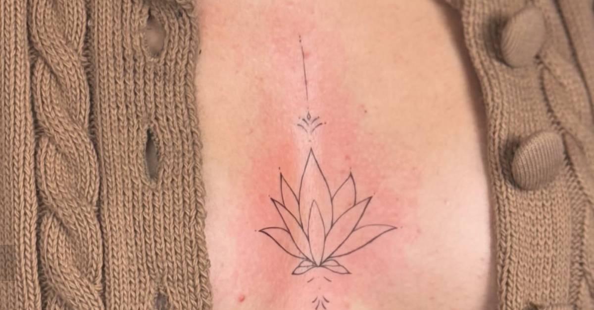 Ornamental lotus flower tattoo in fine line style