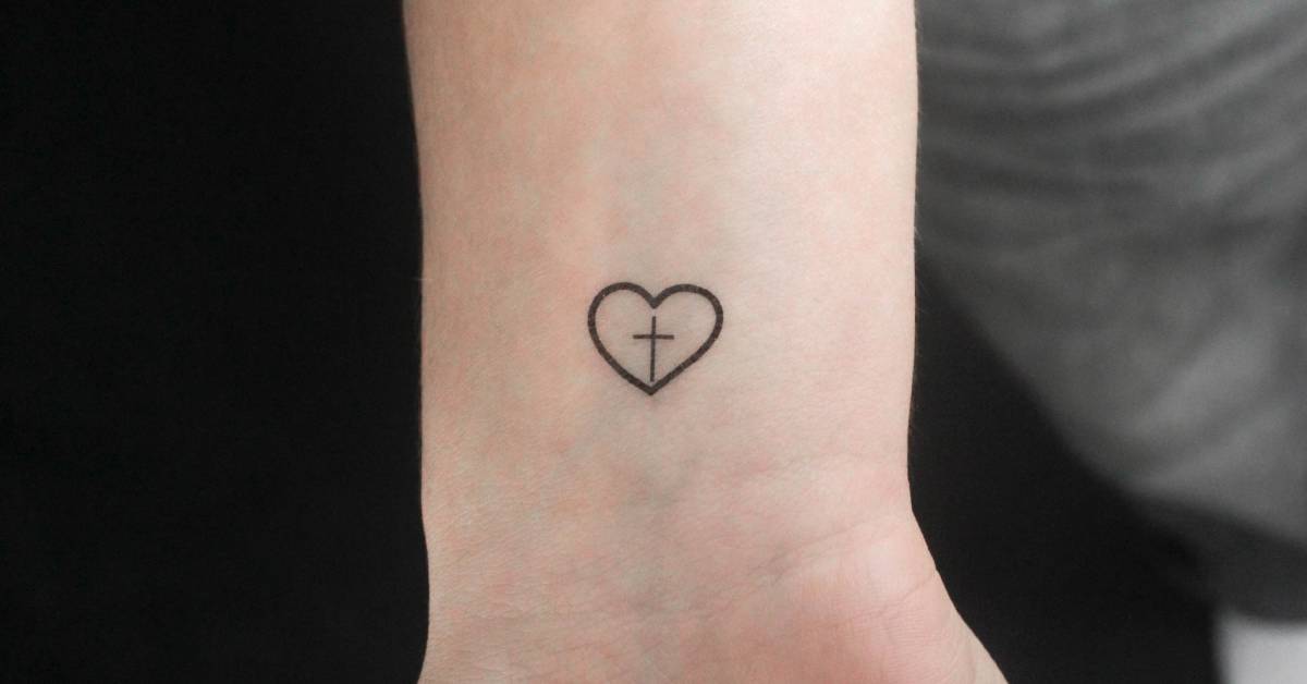 Minimalistic style cross inside heart temporary tattoo.