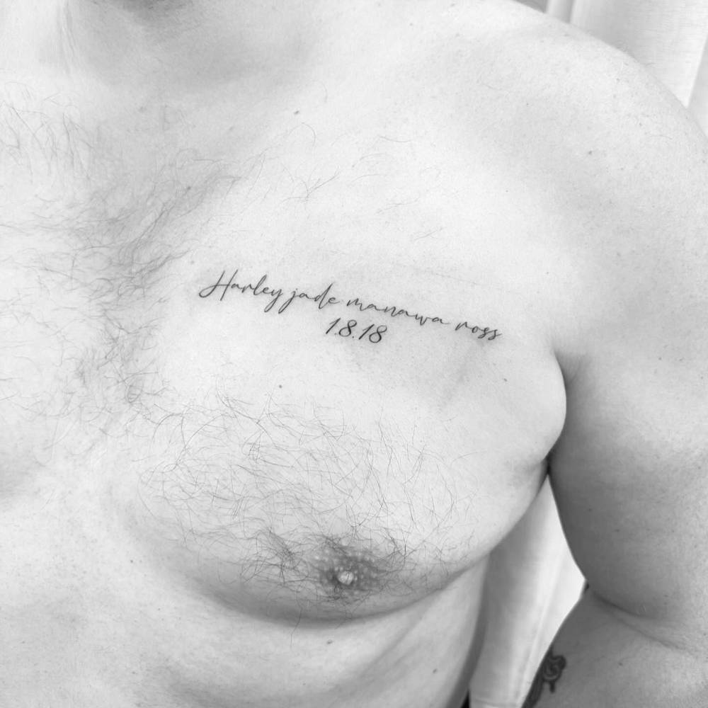 Name and birth date tattooed on the chest.