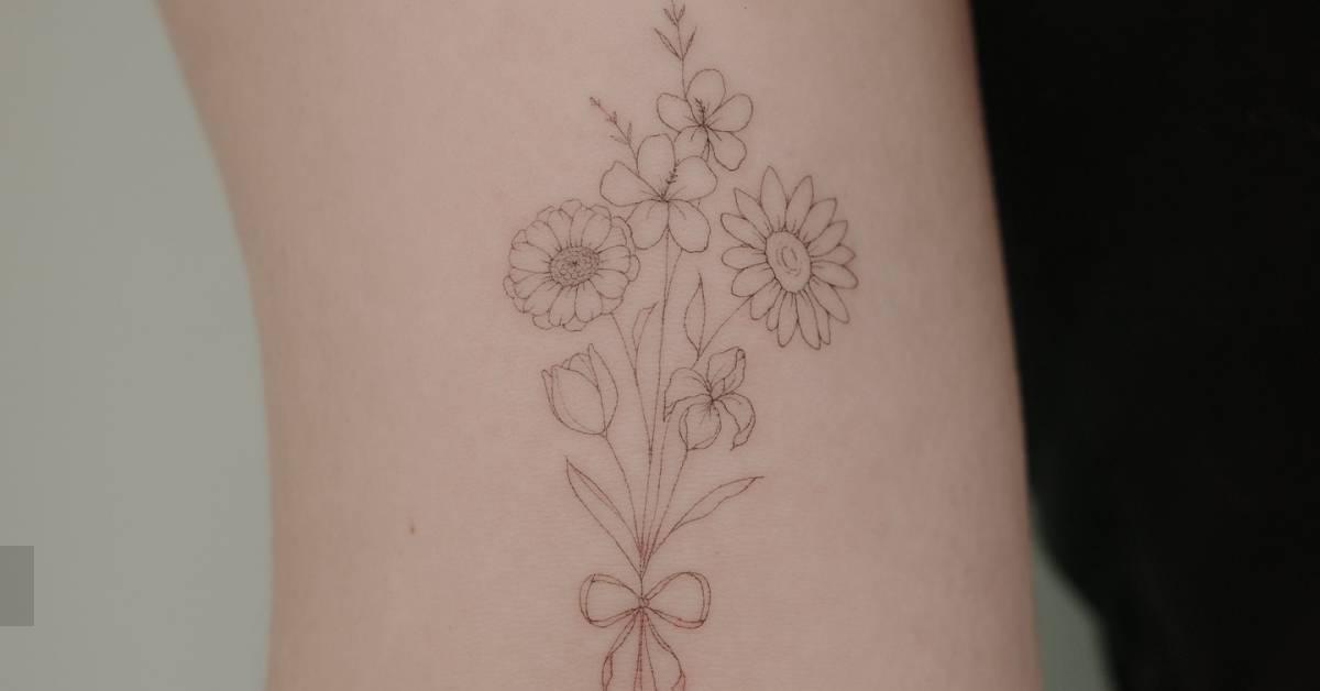 Fine line style flower bouquet tattoo placed on the