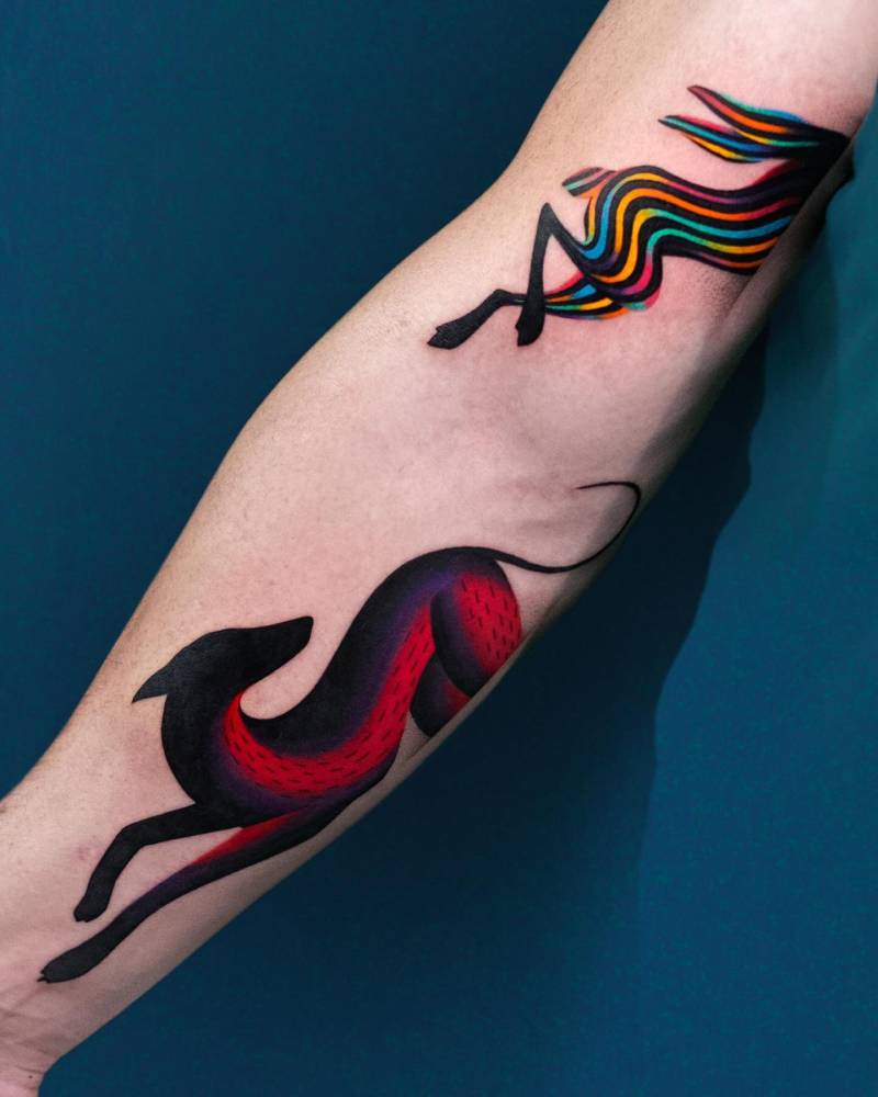 Pop art style greyhound tattoo located on the inner forearm.