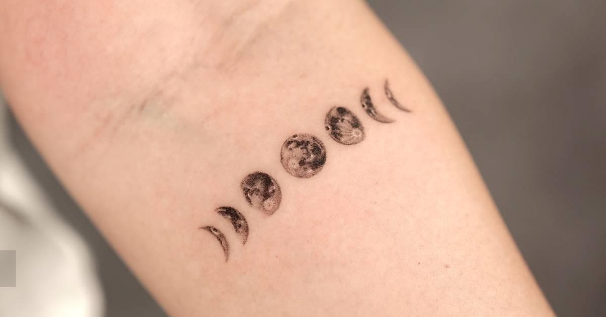 Moon phases tattoo located on the inner forearm,