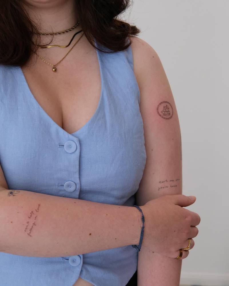 Lettering tattoo that says "can't help falling in love" located on the forearm.