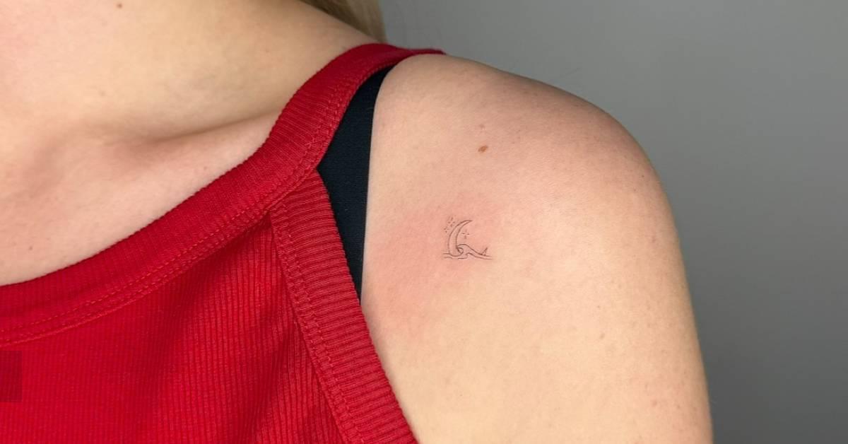 Crescent moon and wave tattoo in fine line style placed
