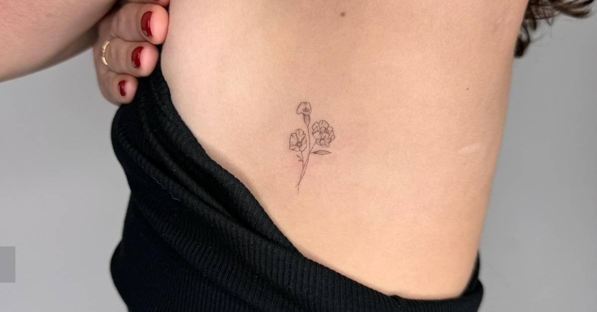 Single needle flower bouquet tattoo located on the side