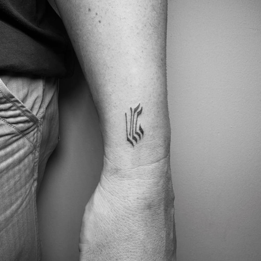 Hebrew lettering tattoo located on the wrist.
