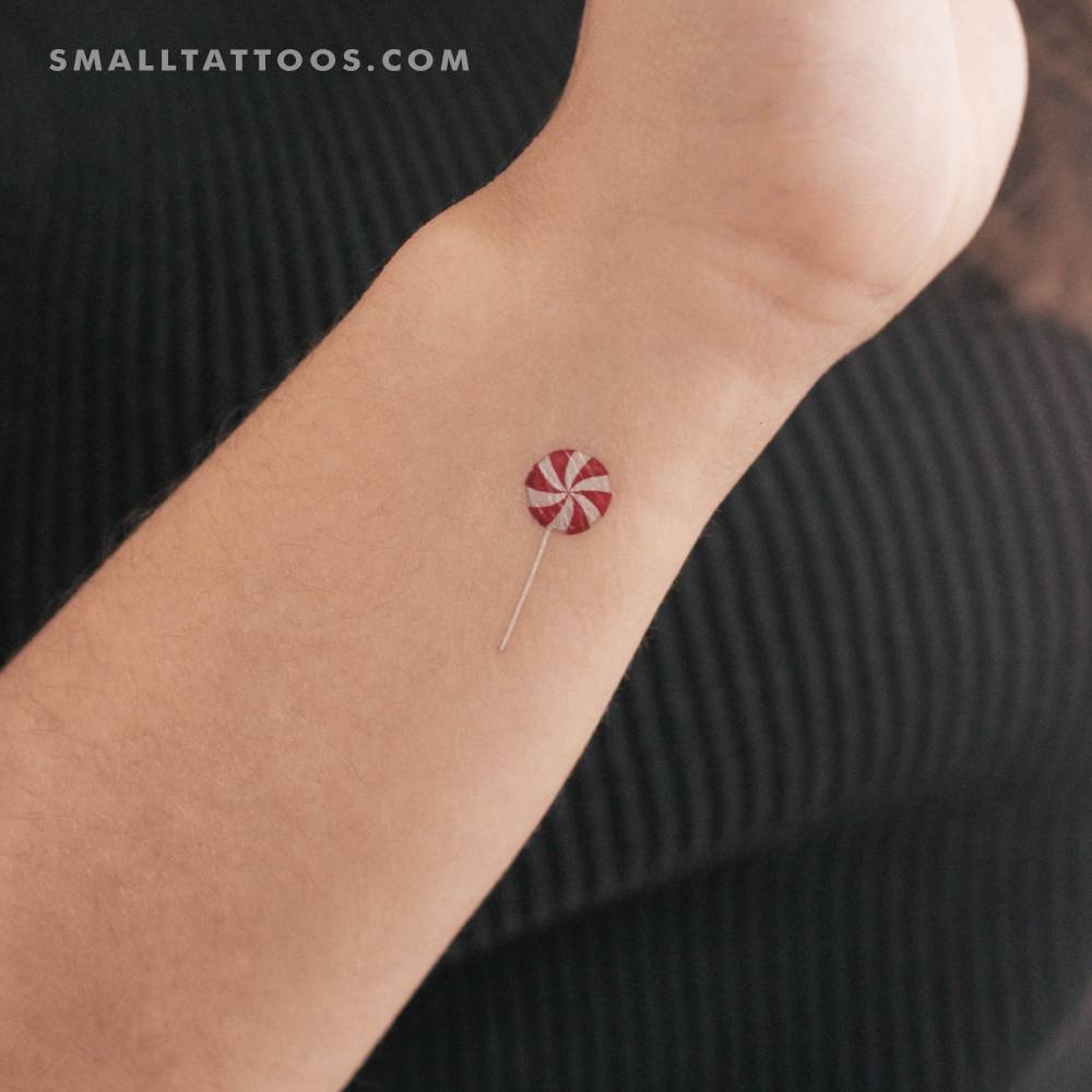 Swirly lollipop temporary tattoo located on the wrist.