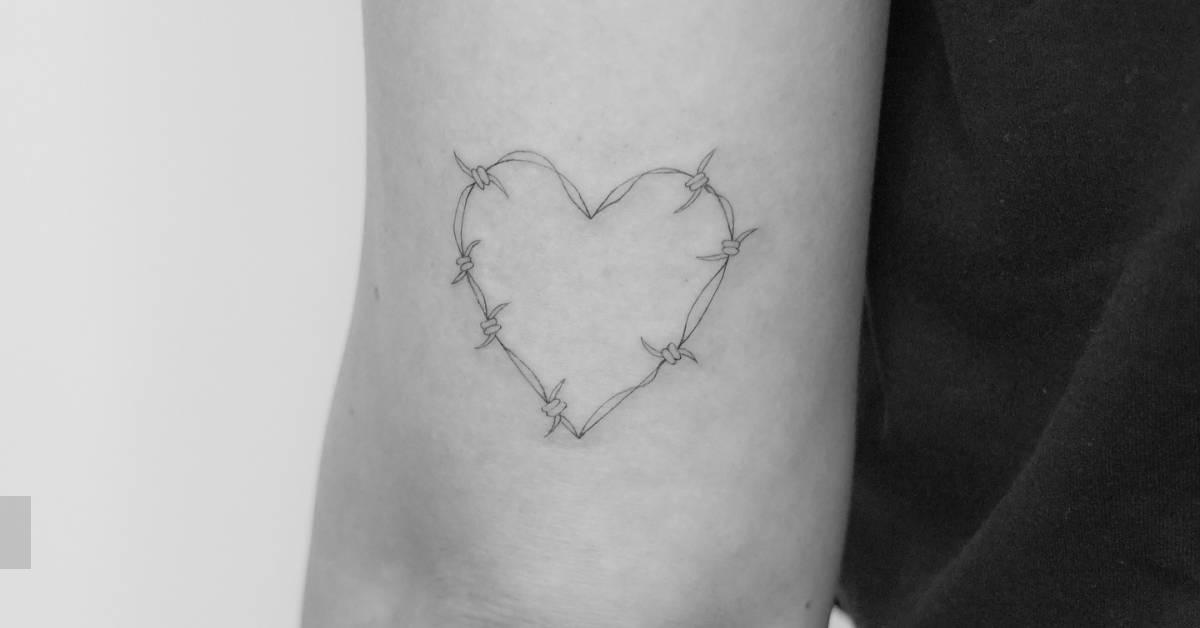 Barbed wire heart tattoo located on the tricep.