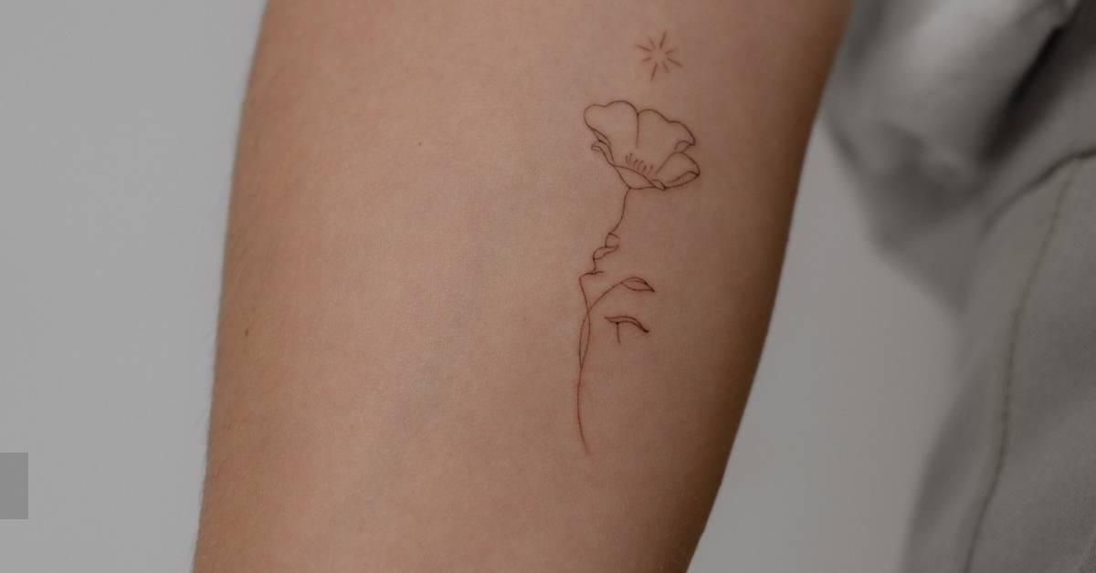 Flower head woman tattoo in fine line style located on